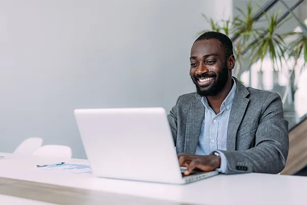 Happy man using his computer